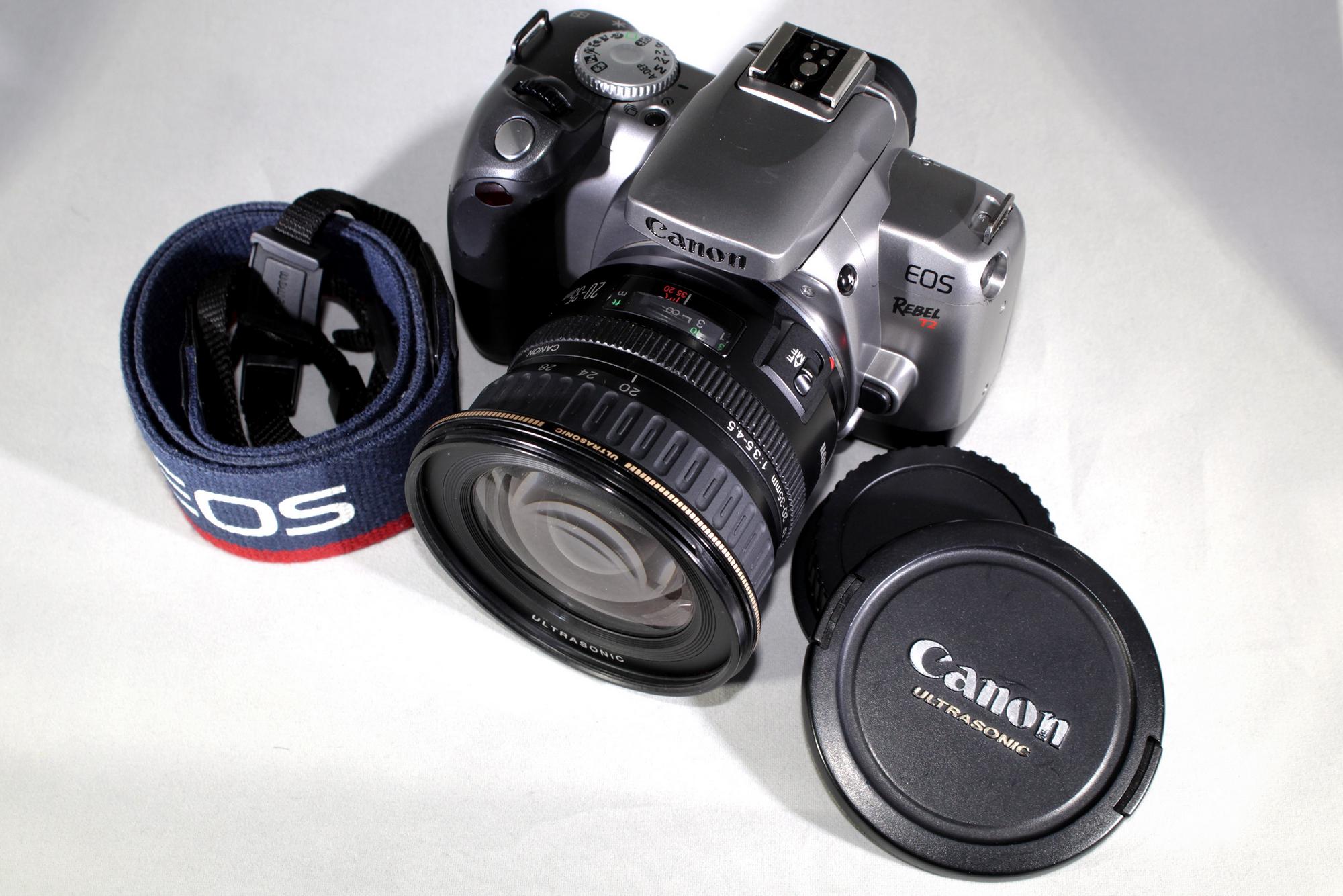 Canon EOS Rebel T2 SLR film camera bundled w/Canon Zoom EF 20-35mm f/3.5-4.5 usm and original strap!. Working & in excellent shape!